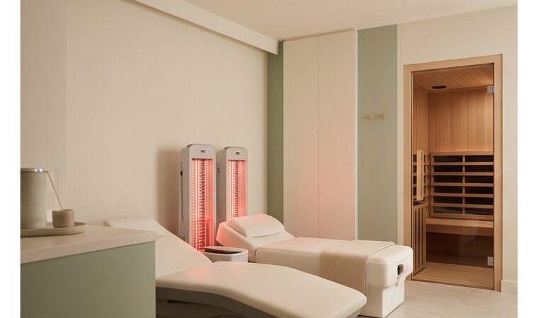 A serene wellness-technology suite with red-light therapy and an infrared sauna